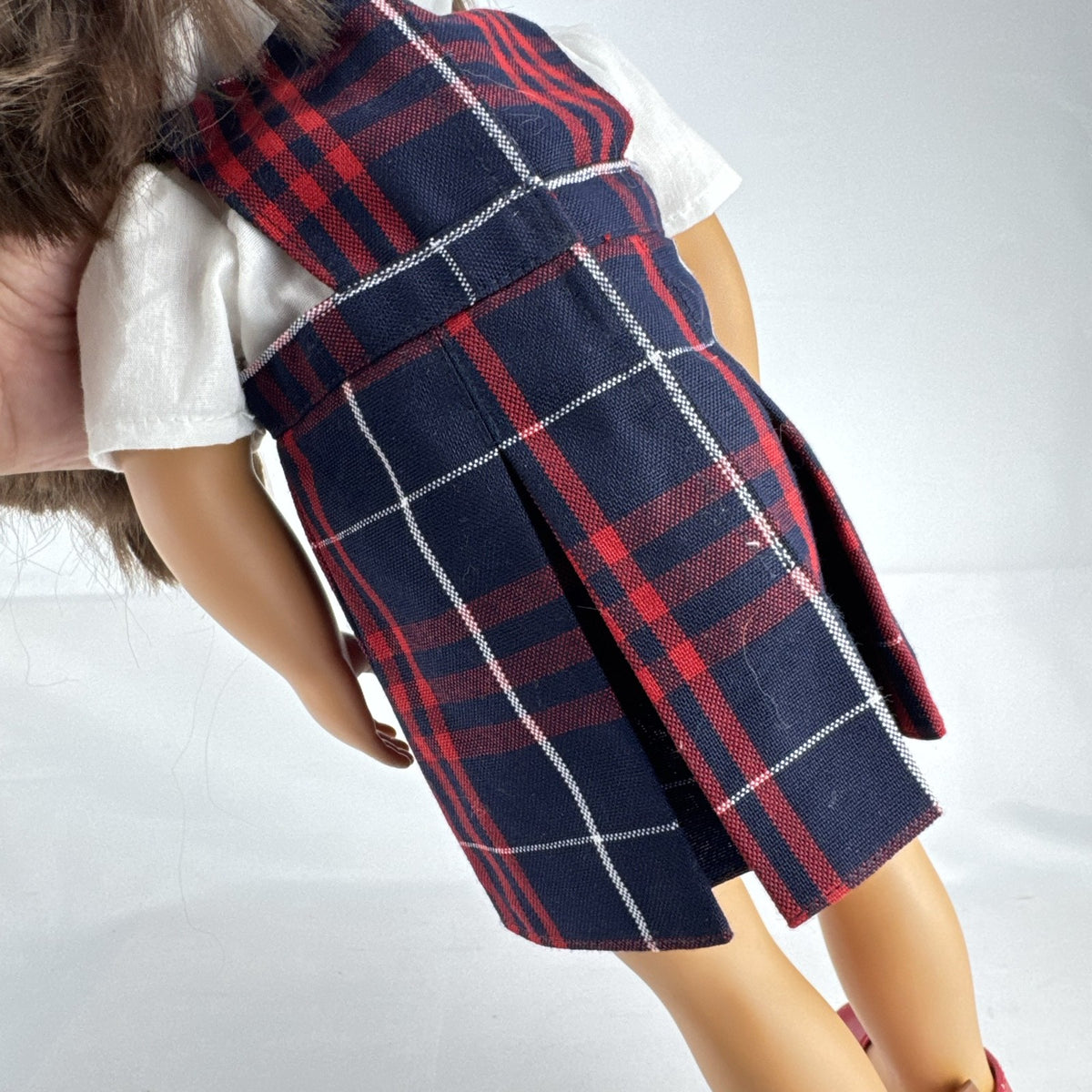 Battat Our Generation 18-inch doll with brown hair and eyes in red and navy plaid school uniform dress and red shoes