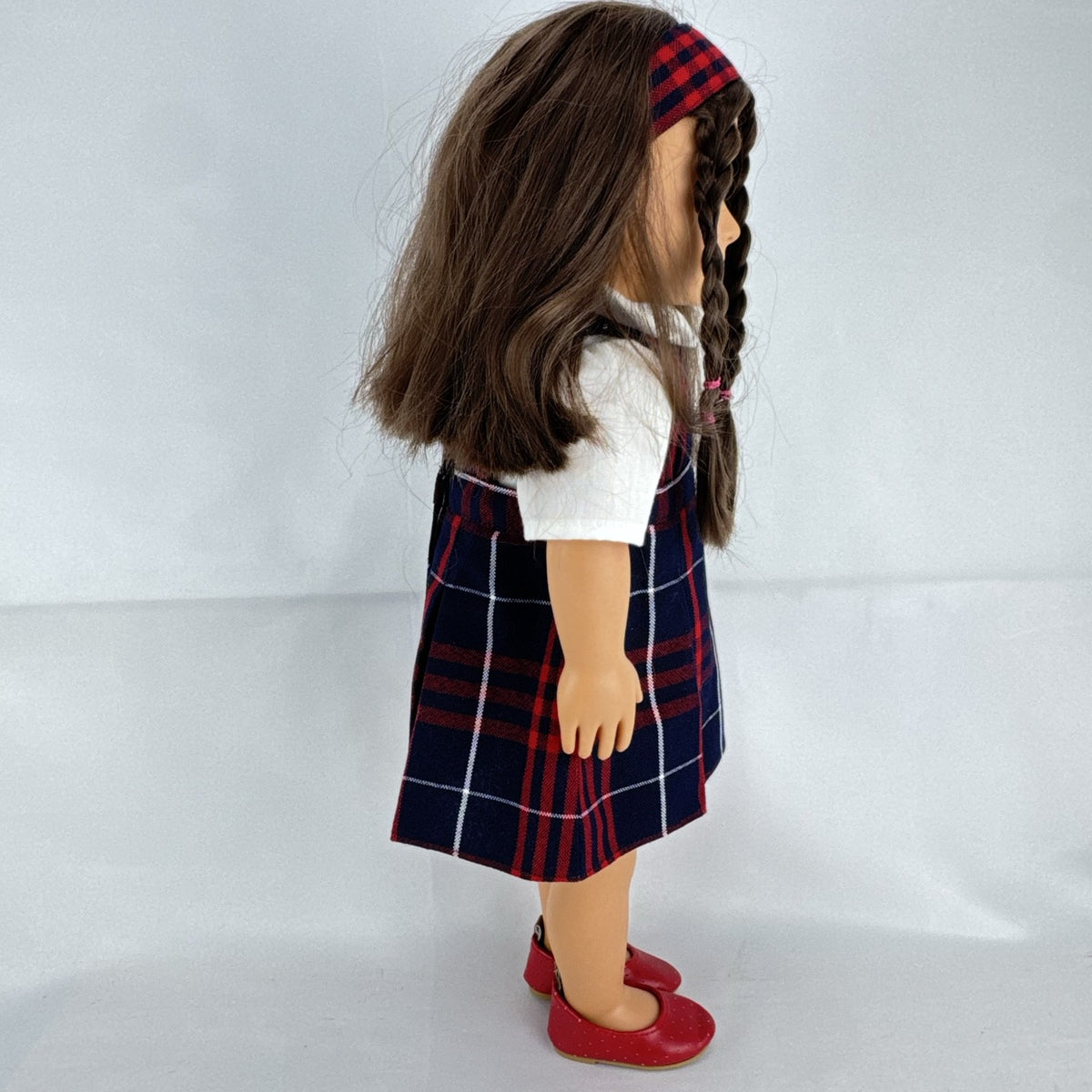 Battat Our Generation 18-inch doll with brown hair and eyes in red and navy plaid school uniform dress and red shoes
