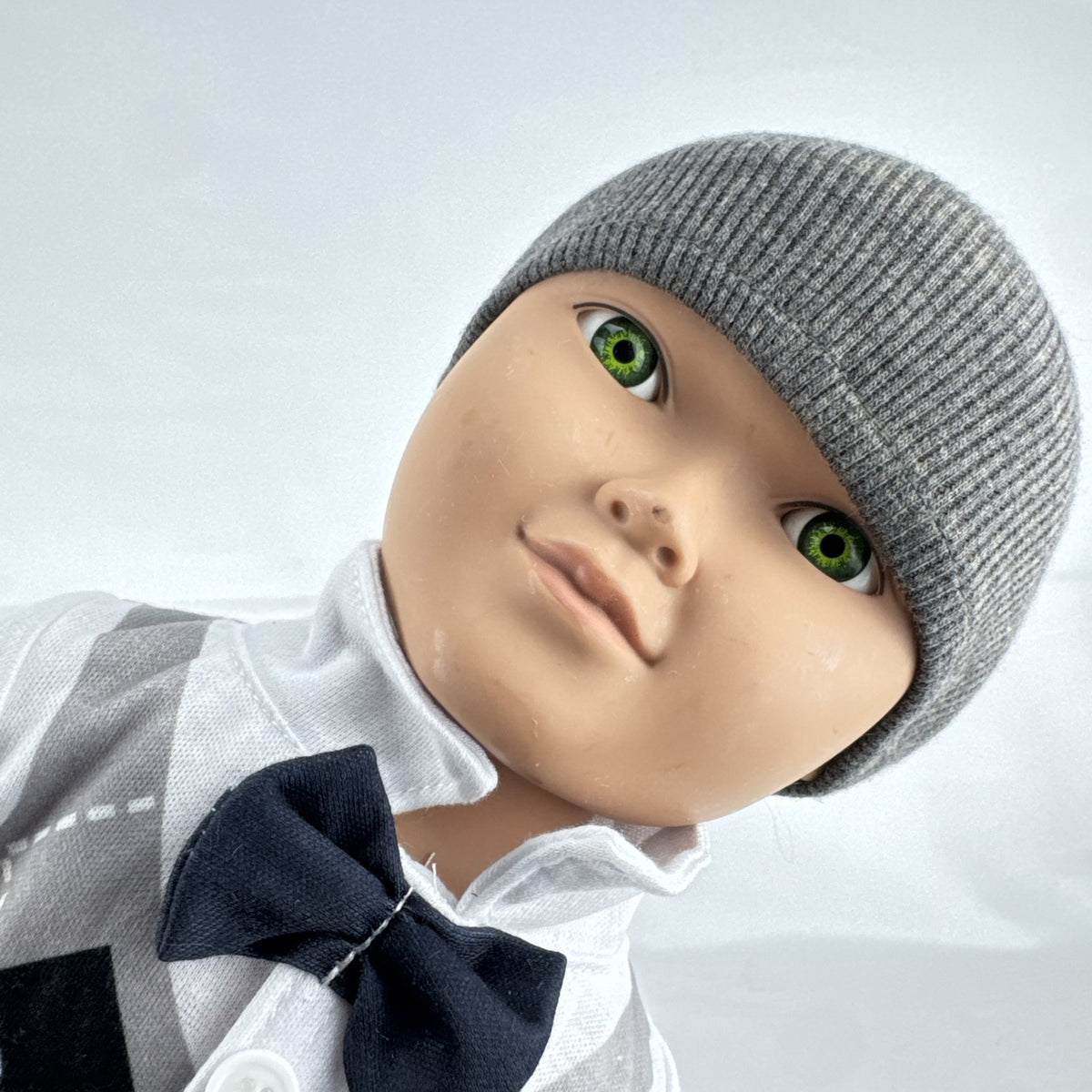 Cititoy 18-inch boy doll with green eyes wearing a knit beanie and argyle vest outfit