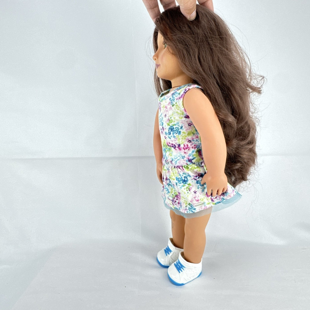 Battat Our Generation 18-inch doll with wavy brown hair, green eyes, and floral dress.