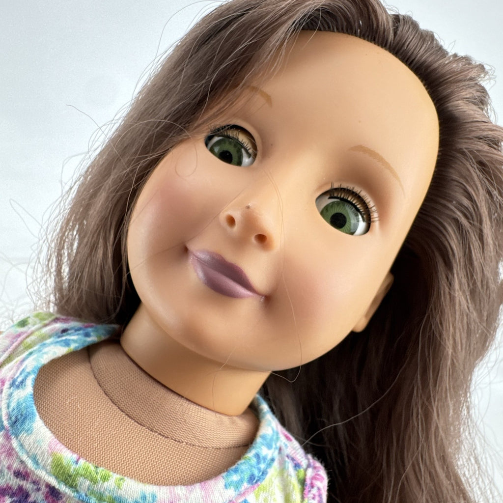 Battat Our Generation 18-inch doll with wavy brown hair, green eyes, and floral dress.