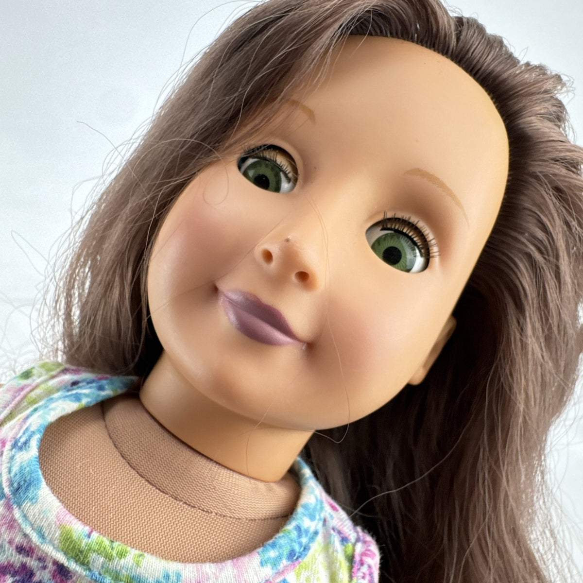 Battat Our Generation 18-inch doll with wavy brown hair, green eyes, and floral dress.