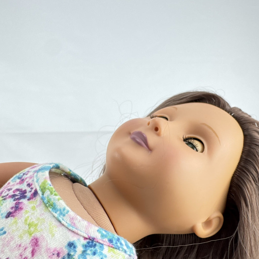 Battat Our Generation 18-inch doll with wavy brown hair, green eyes, and floral dress.