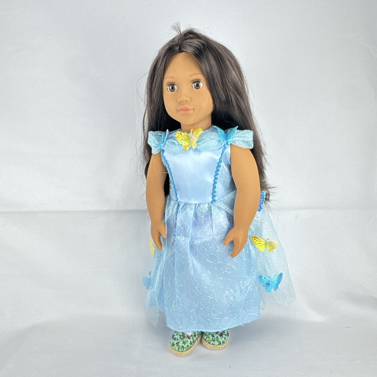 Our Generation 18-inch doll by Battat wearing a light blue butterfly princess dress and patterned shoes