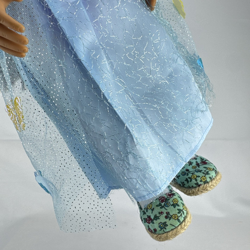 Our Generation 18-inch doll by Battat wearing a light blue butterfly princess dress and patterned shoes