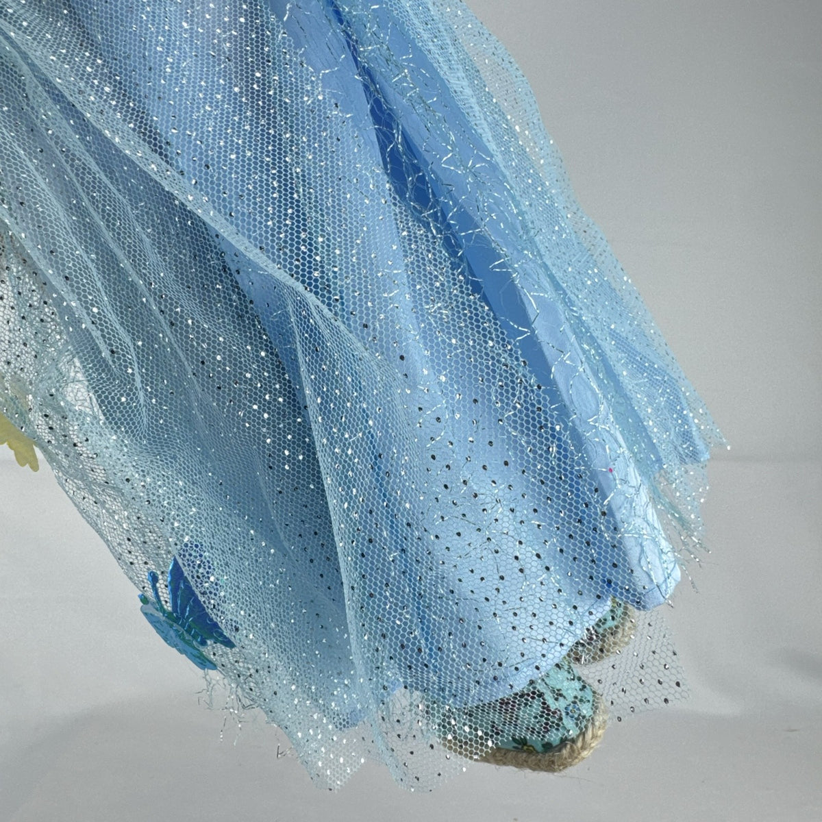 Our Generation 18-inch doll by Battat wearing a light blue butterfly princess dress and patterned shoes