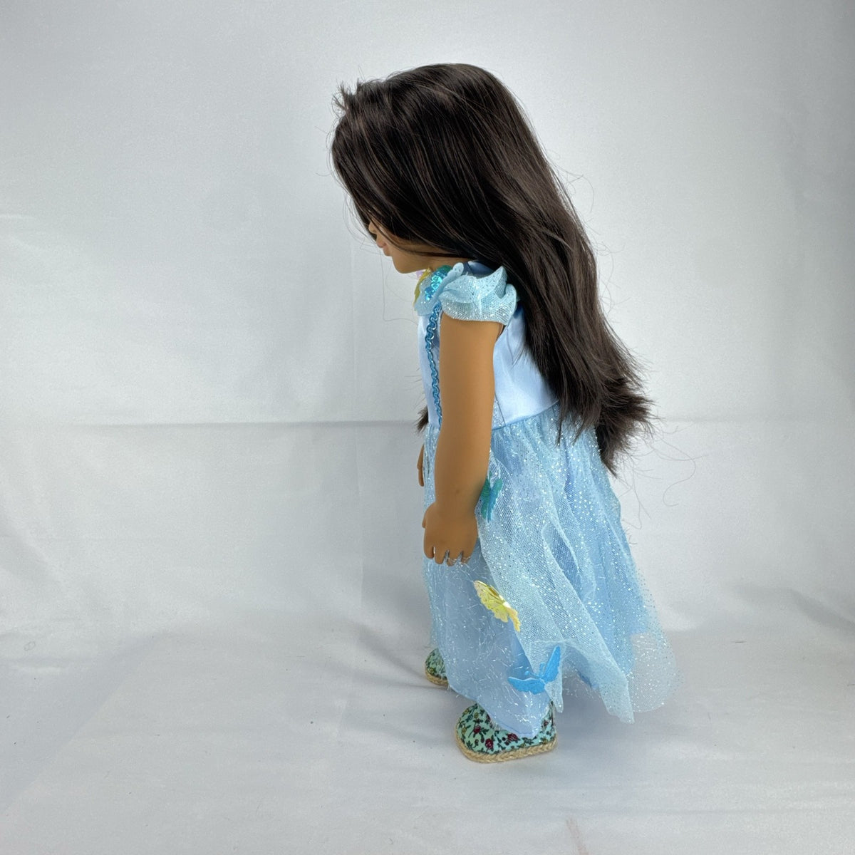 Our Generation 18-inch doll by Battat wearing a light blue butterfly princess dress and patterned shoes
