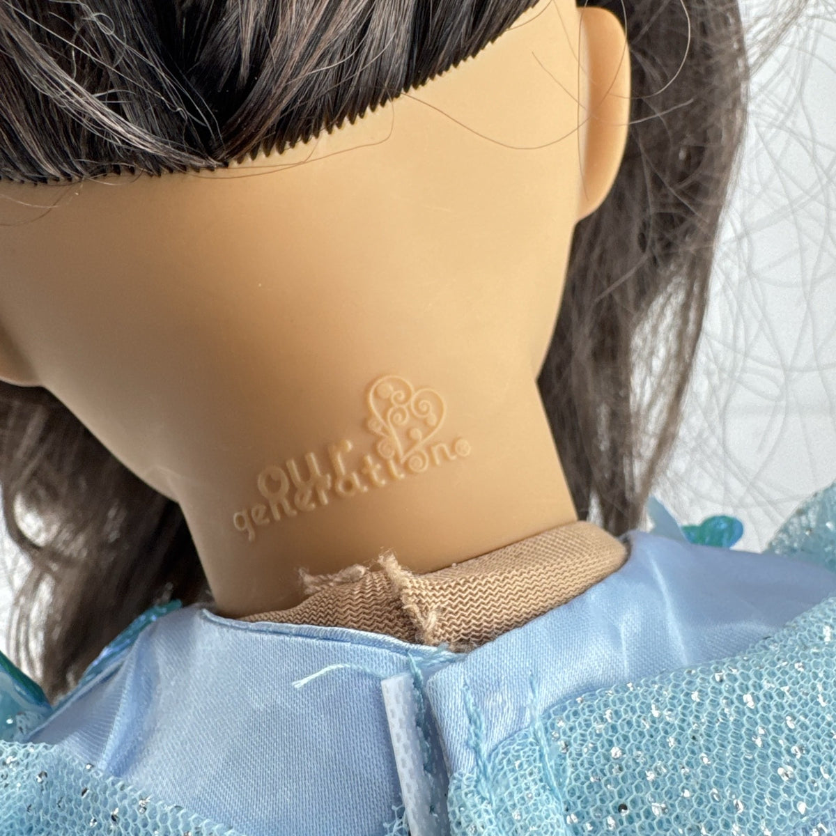 Our Generation 18-inch doll by Battat wearing a light blue butterfly princess dress and patterned shoes