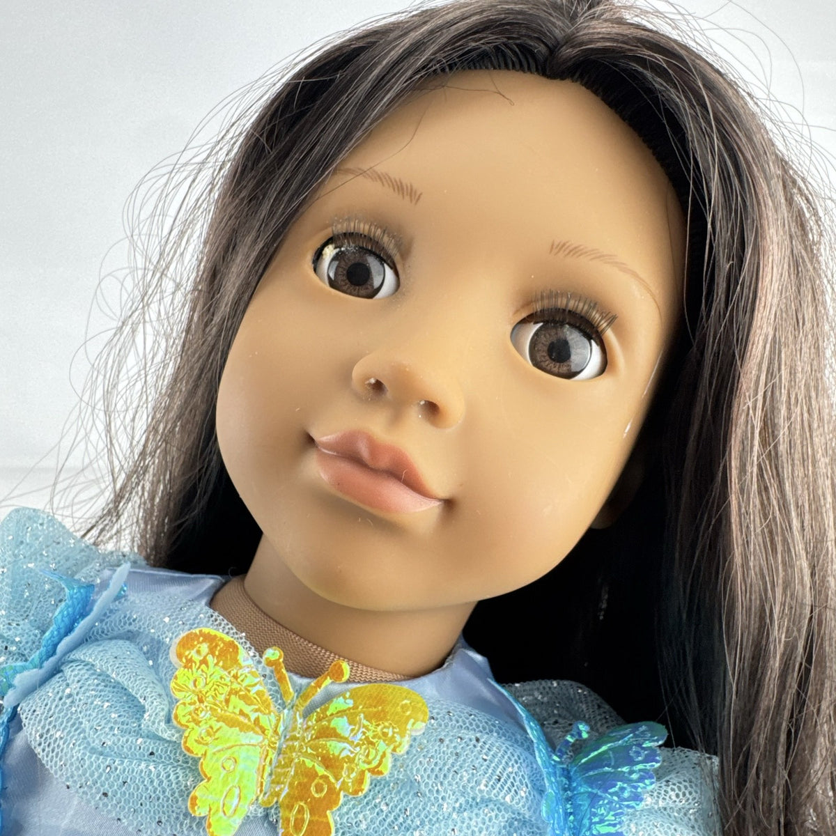 Our Generation 18-inch doll by Battat wearing a light blue butterfly princess dress and patterned shoes