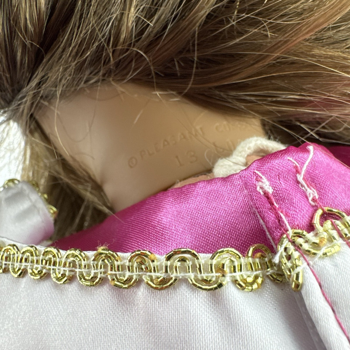 18-inch Pleasant Company American Girl doll with brown hair and brown eyes wearing pink and gold princess outfit