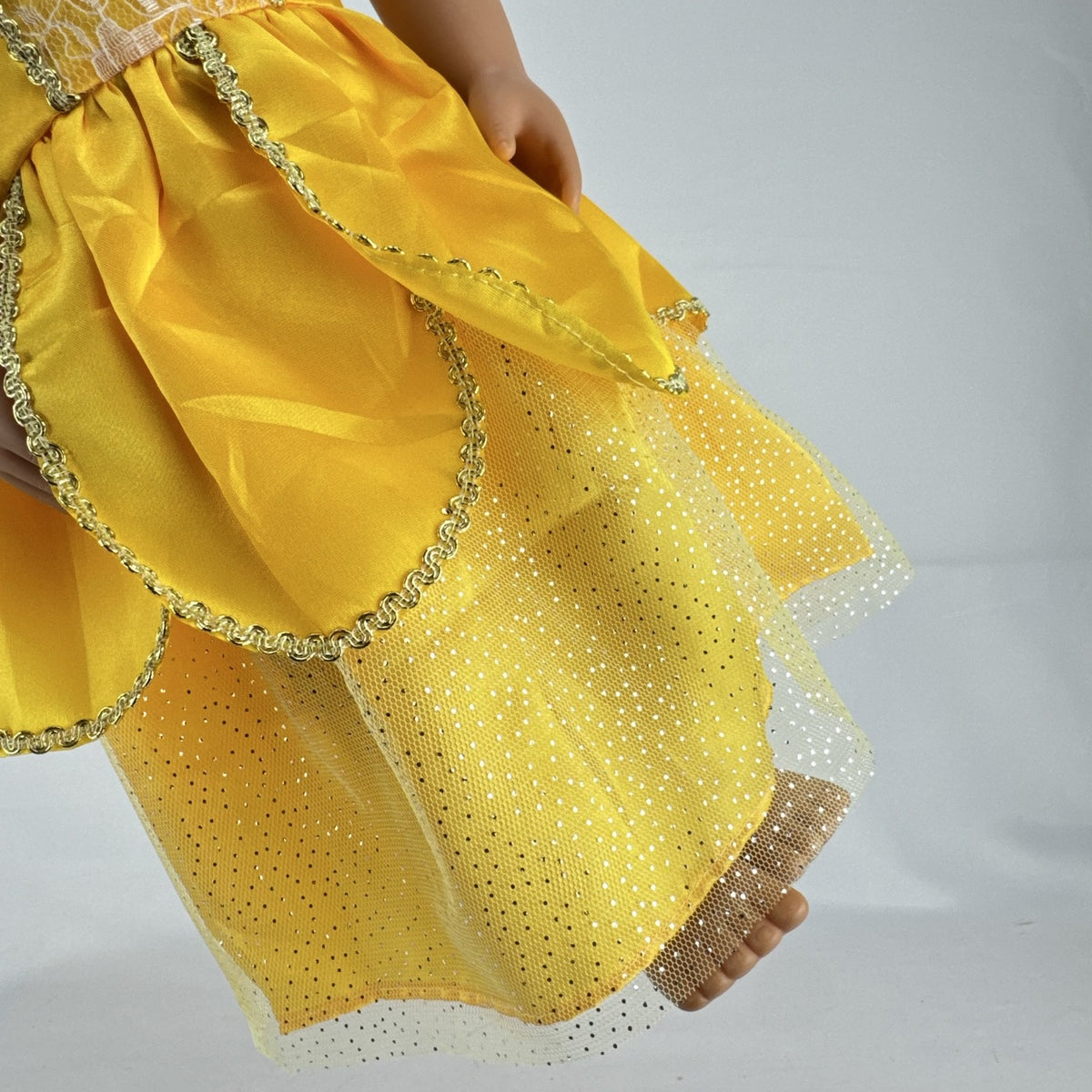 Our Generation 18-inch blonde doll with blue eyes wearing a yellow princess ballgown