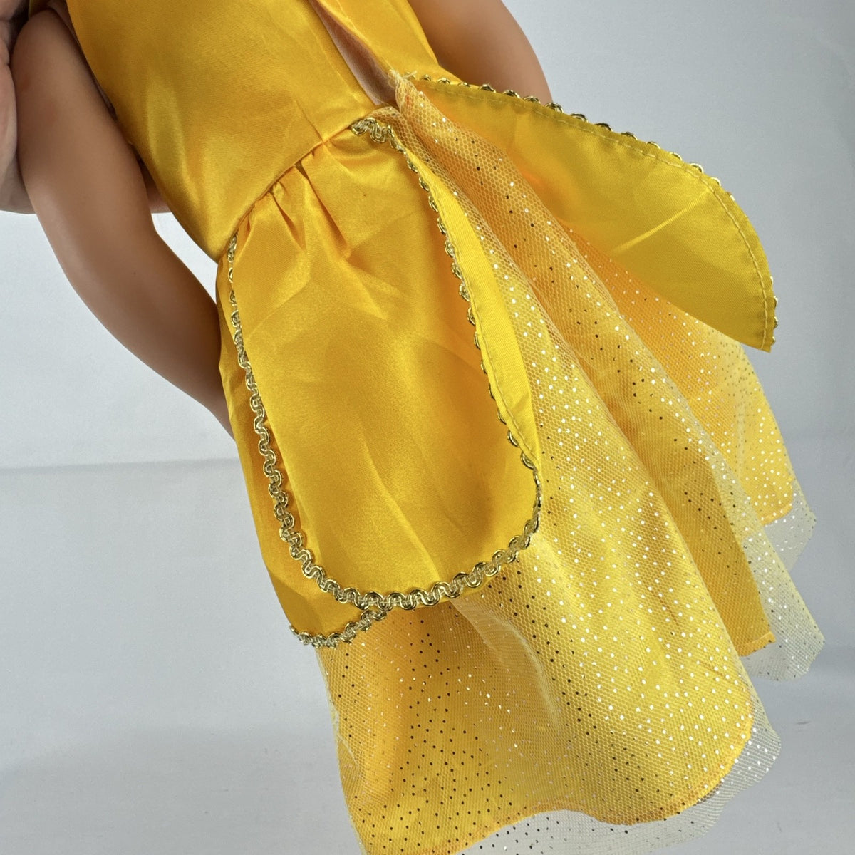 Our Generation 18-inch blonde doll with blue eyes wearing a yellow princess ballgown