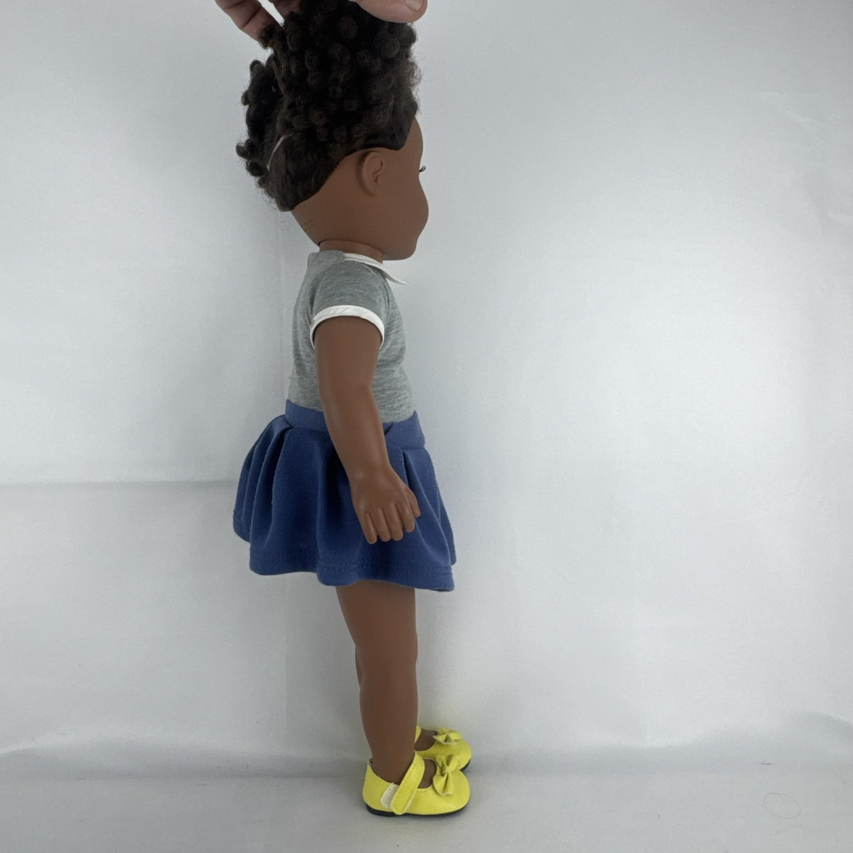 Cititoy 18-inch vinyl African American girl doll wearing grey shirt, blue skirt, and yellow shoes