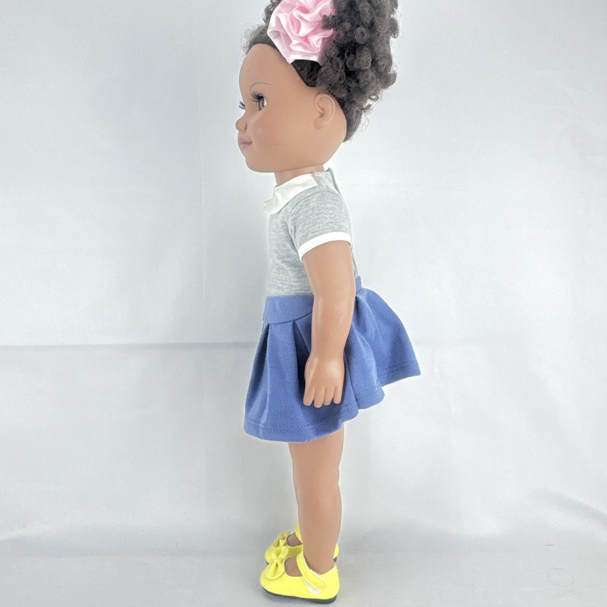 Cititoy 18-inch vinyl African American girl doll wearing grey shirt, blue skirt, and yellow shoes