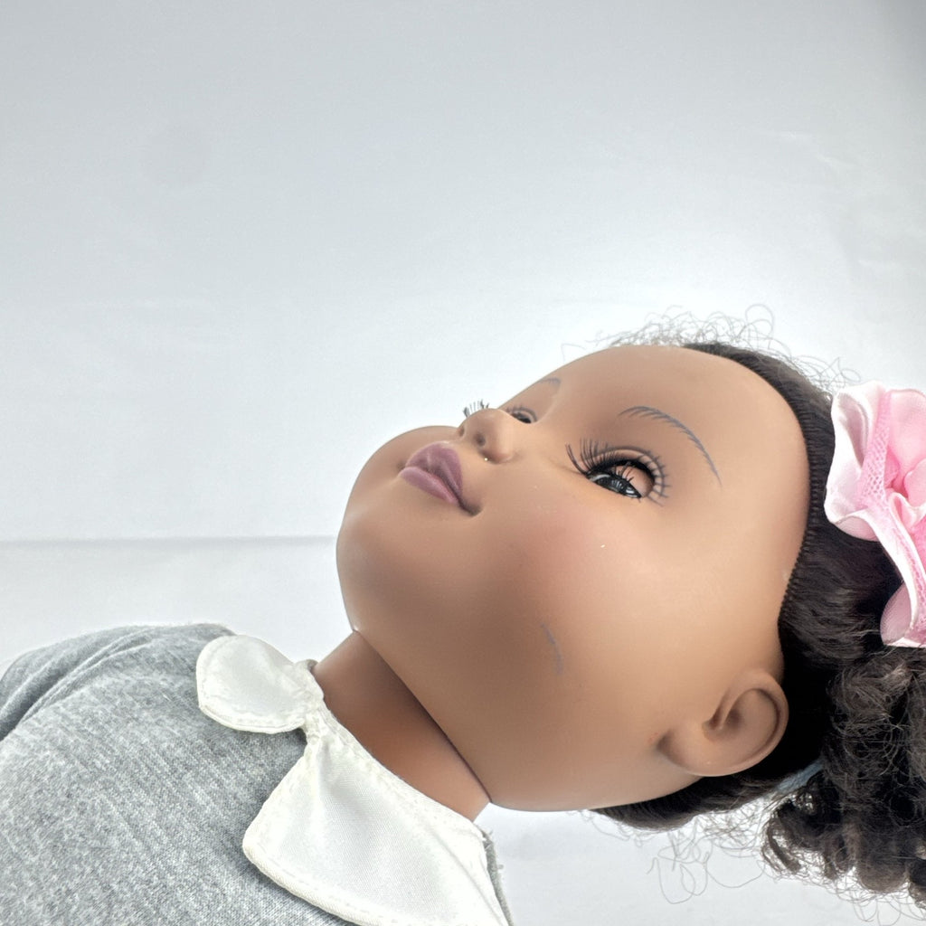Cititoy 18-inch vinyl African American girl doll wearing grey shirt, blue skirt, and yellow shoes