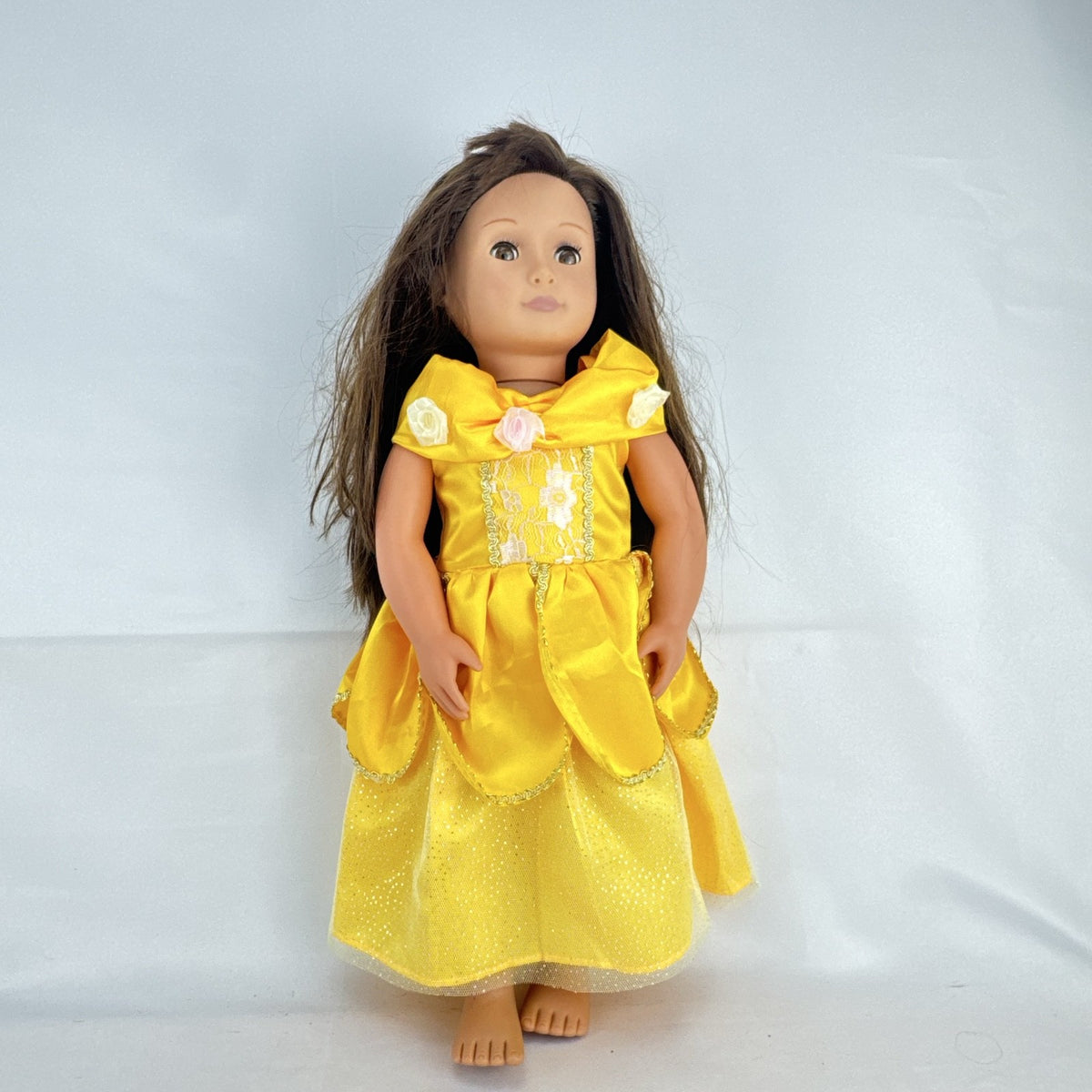 Battat Our Generation 18-inch doll with brown hair and eyes wearing a yellow princess gown