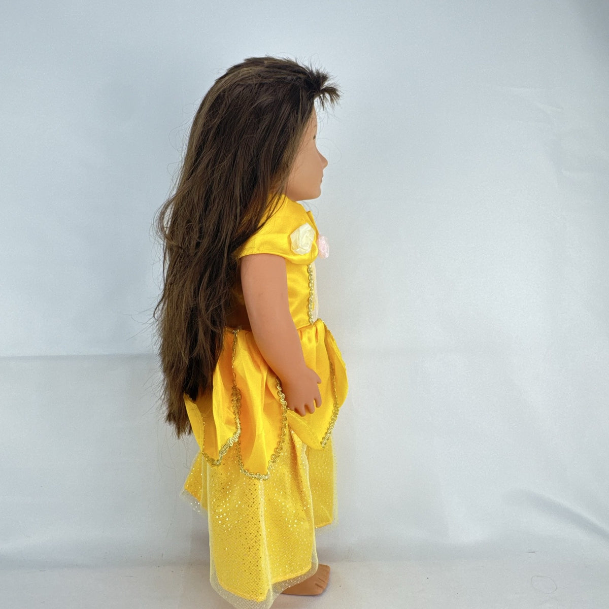 Battat Our Generation 18-inch doll with brown hair and eyes wearing a yellow princess gown