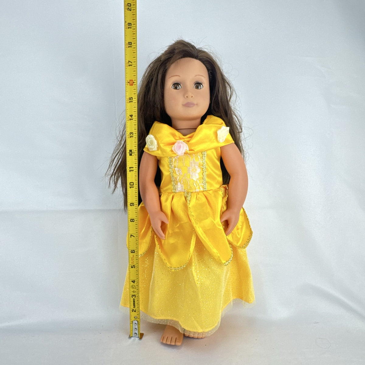 Battat Our Generation 18-inch doll with brown hair and eyes wearing a yellow princess gown