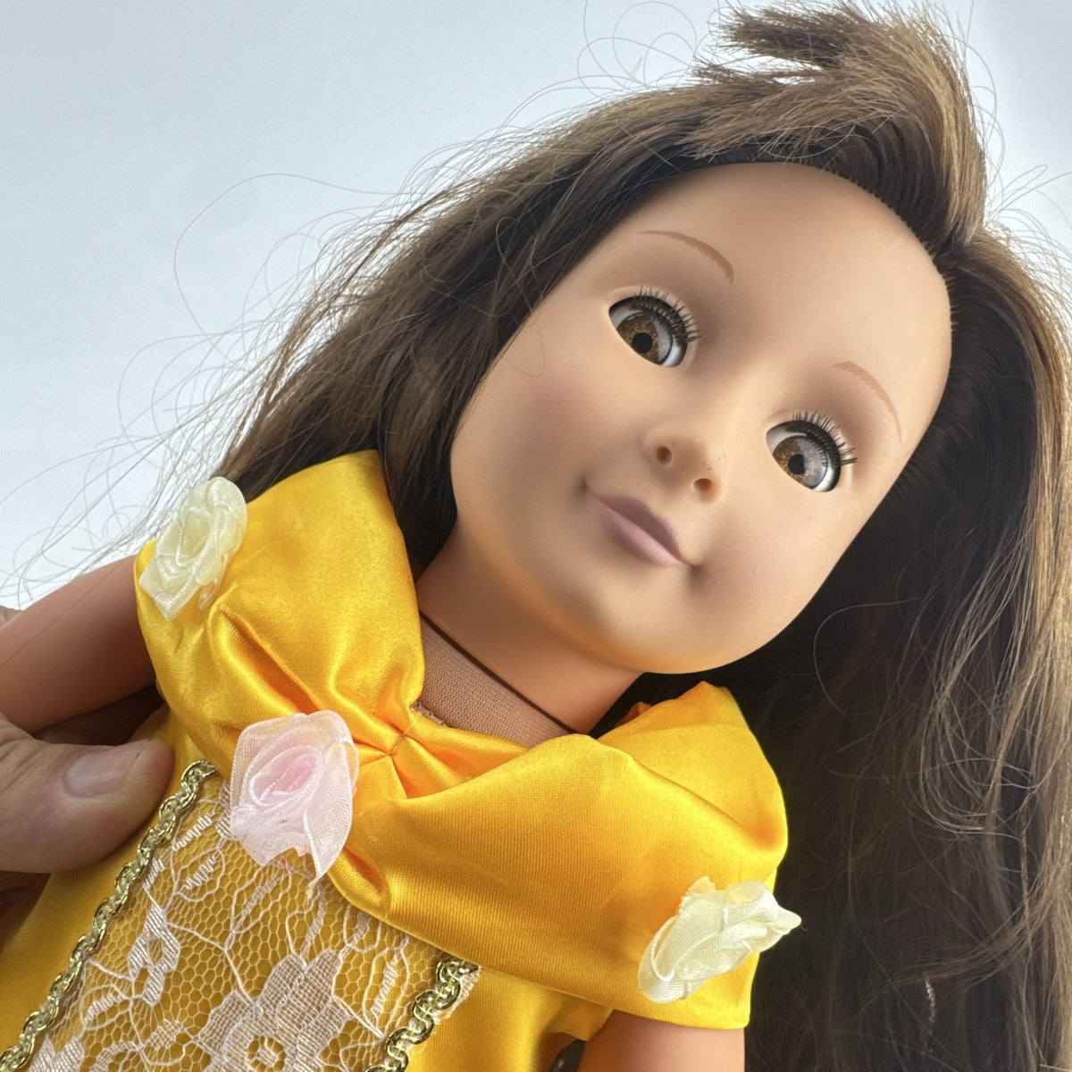 Battat Our Generation 18-inch doll with brown hair and eyes wearing a yellow princess gown