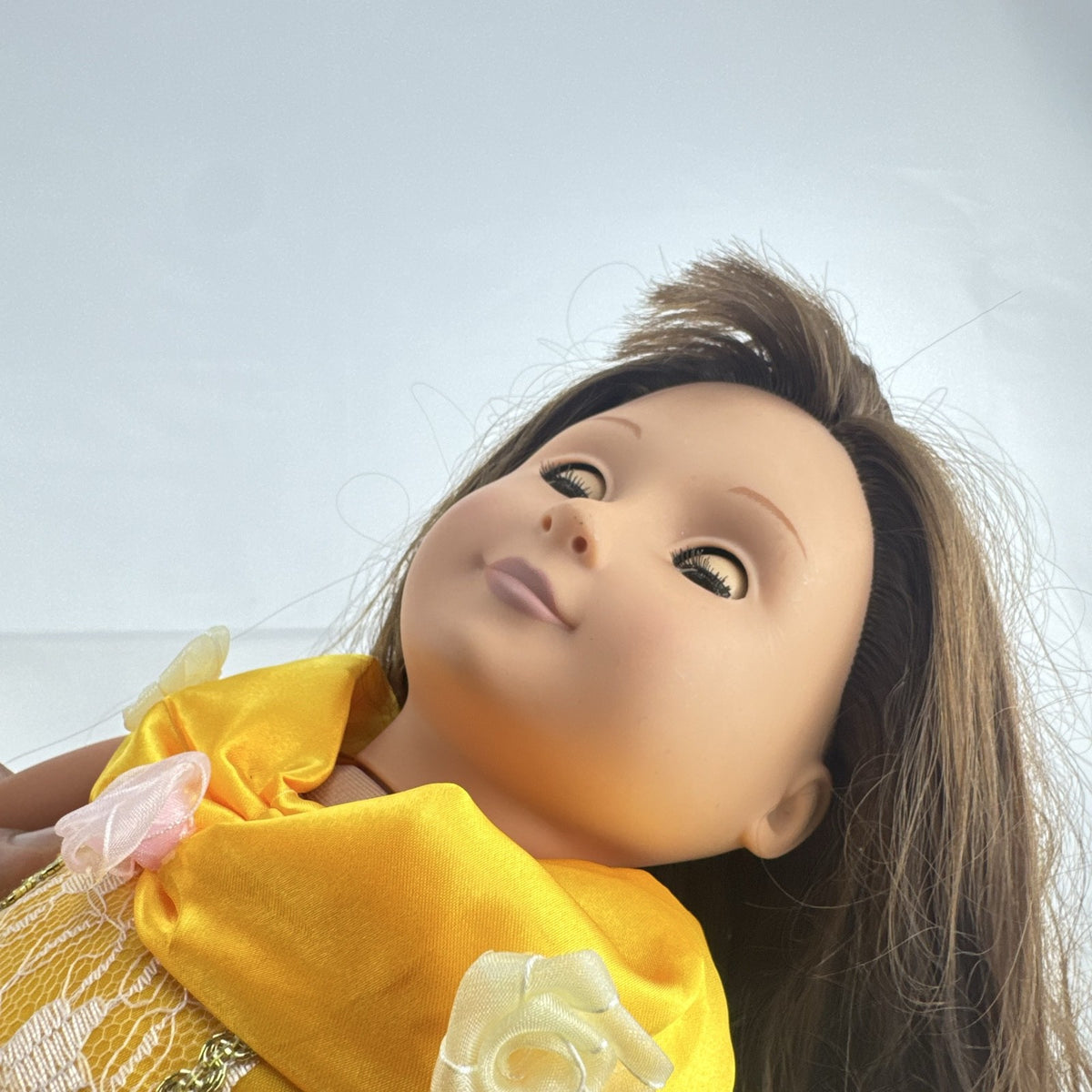 Battat Our Generation 18-inch doll with brown hair and eyes wearing a yellow princess gown