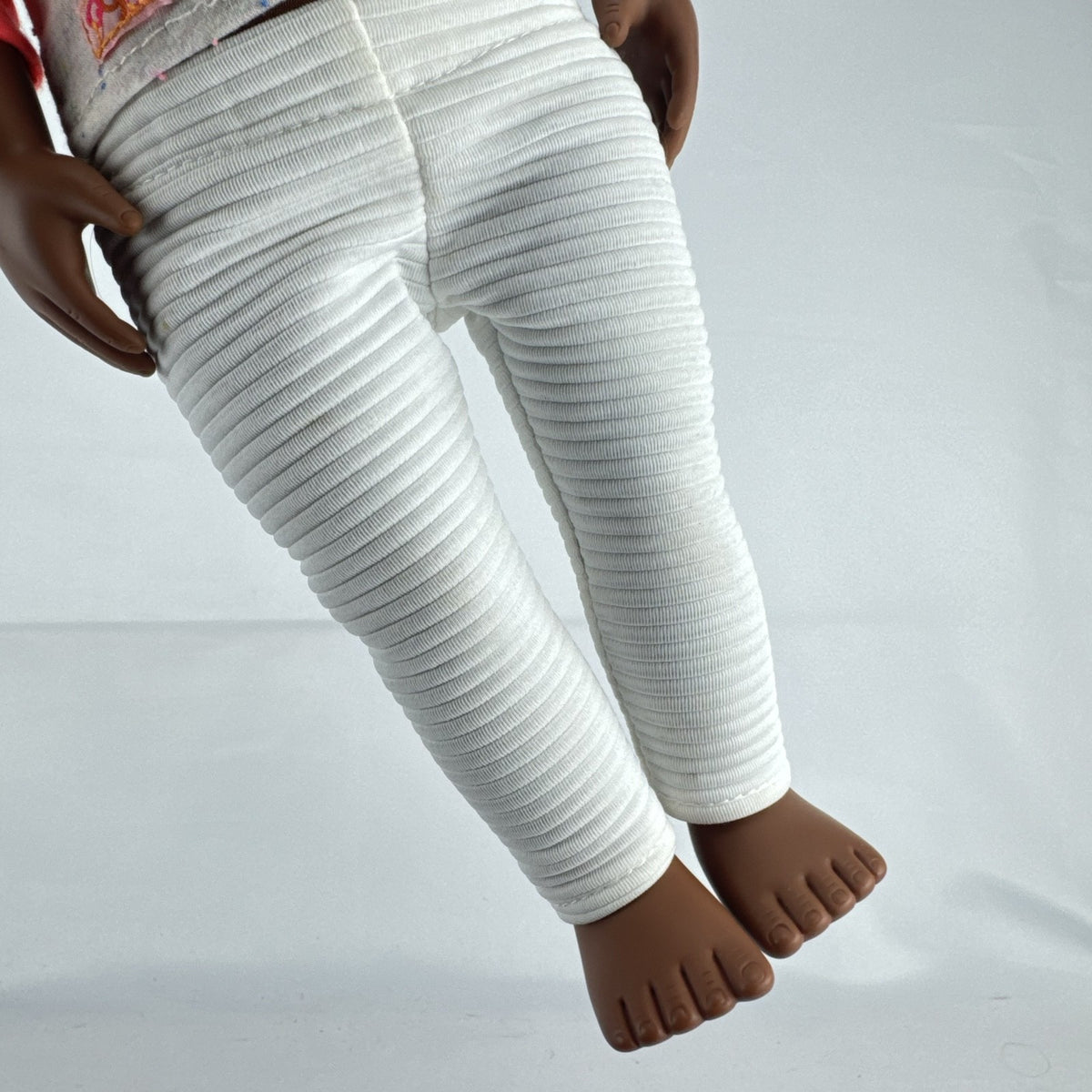 Battat Our Generation 18-inch African American doll with curly dark brown hair wearing a star shirt and white pants