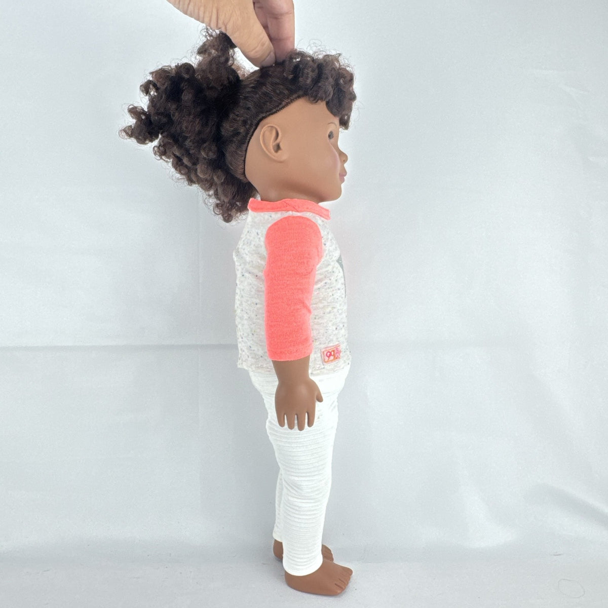 Battat Our Generation 18-inch African American doll with curly dark brown hair wearing a star shirt and white pants