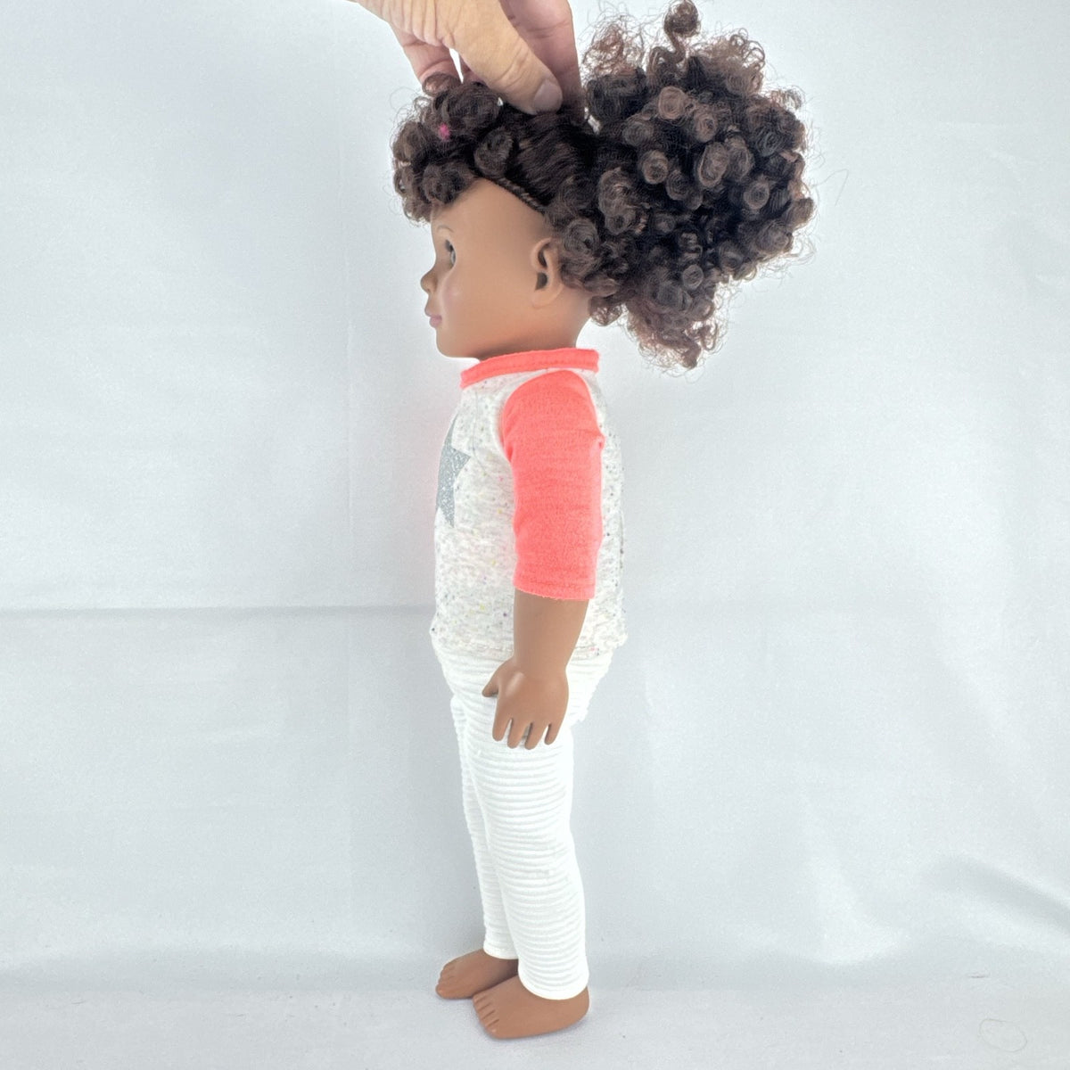 Battat Our Generation 18-inch African American doll with curly dark brown hair wearing a star shirt and white pants