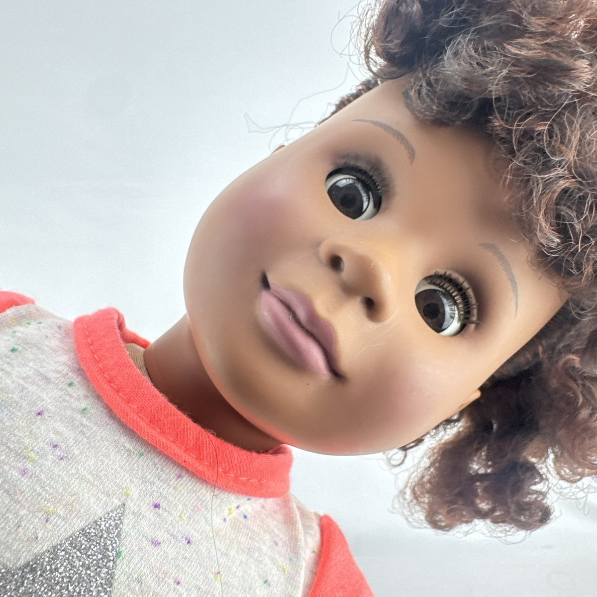 Battat Our Generation 18-inch African American doll with curly dark brown hair wearing a star shirt and white pants