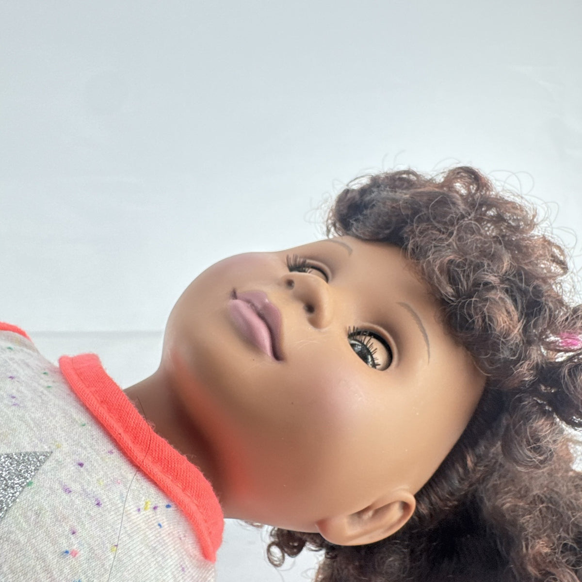 Battat Our Generation 18-inch African American doll with curly dark brown hair wearing a star shirt and white pants