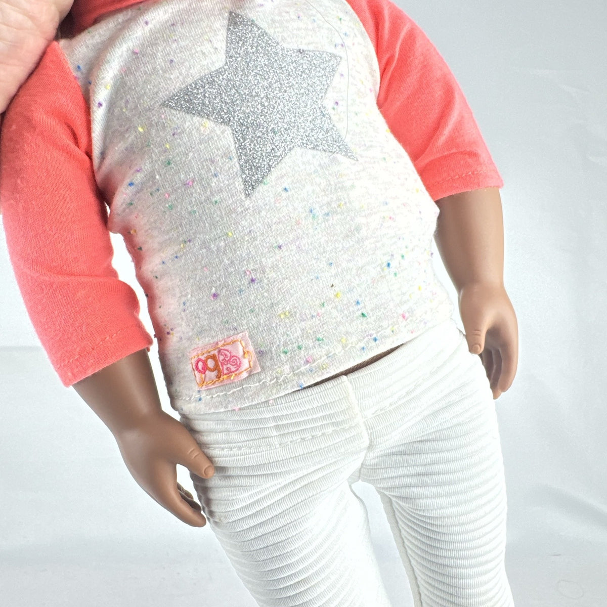 Battat Our Generation 18-inch African American doll with curly dark brown hair wearing a star shirt and white pants