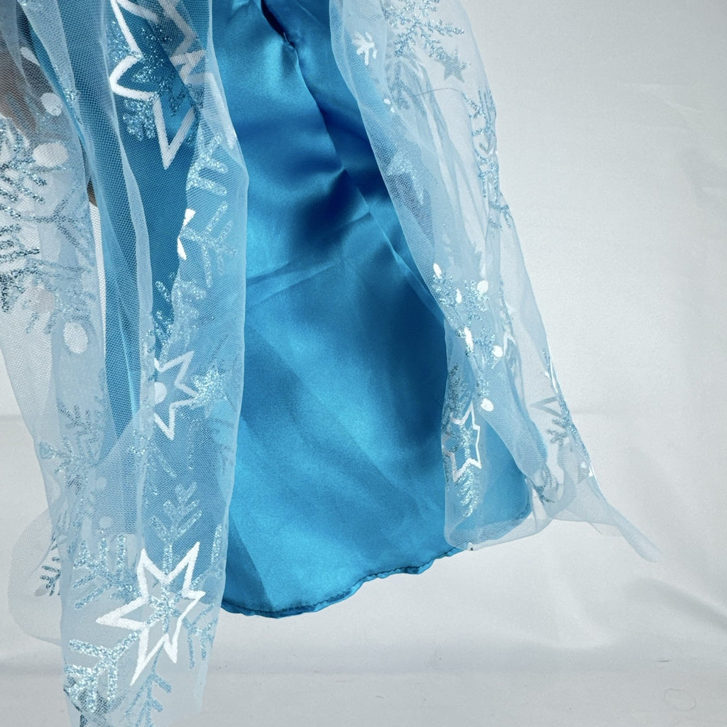 Our Generation 18-inch brunette doll with green eyes wearing a blue sequin ice princess gown and tiara