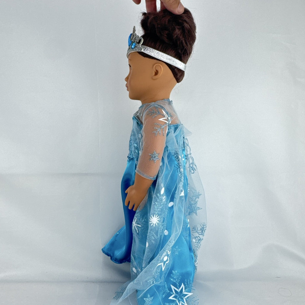 Our Generation 18-inch brunette doll with green eyes wearing a blue sequin ice princess gown and tiara