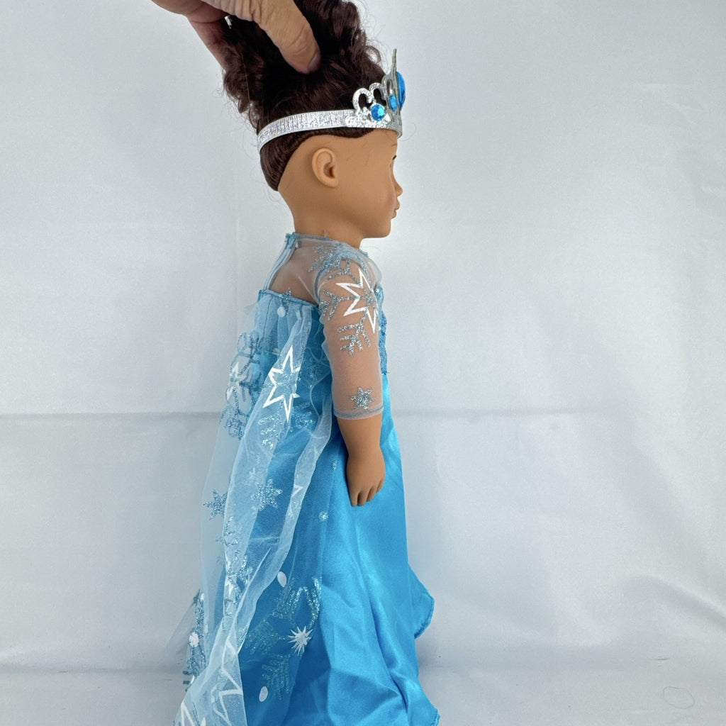 Our Generation 18-inch brunette doll with green eyes wearing a blue sequin ice princess gown and tiara