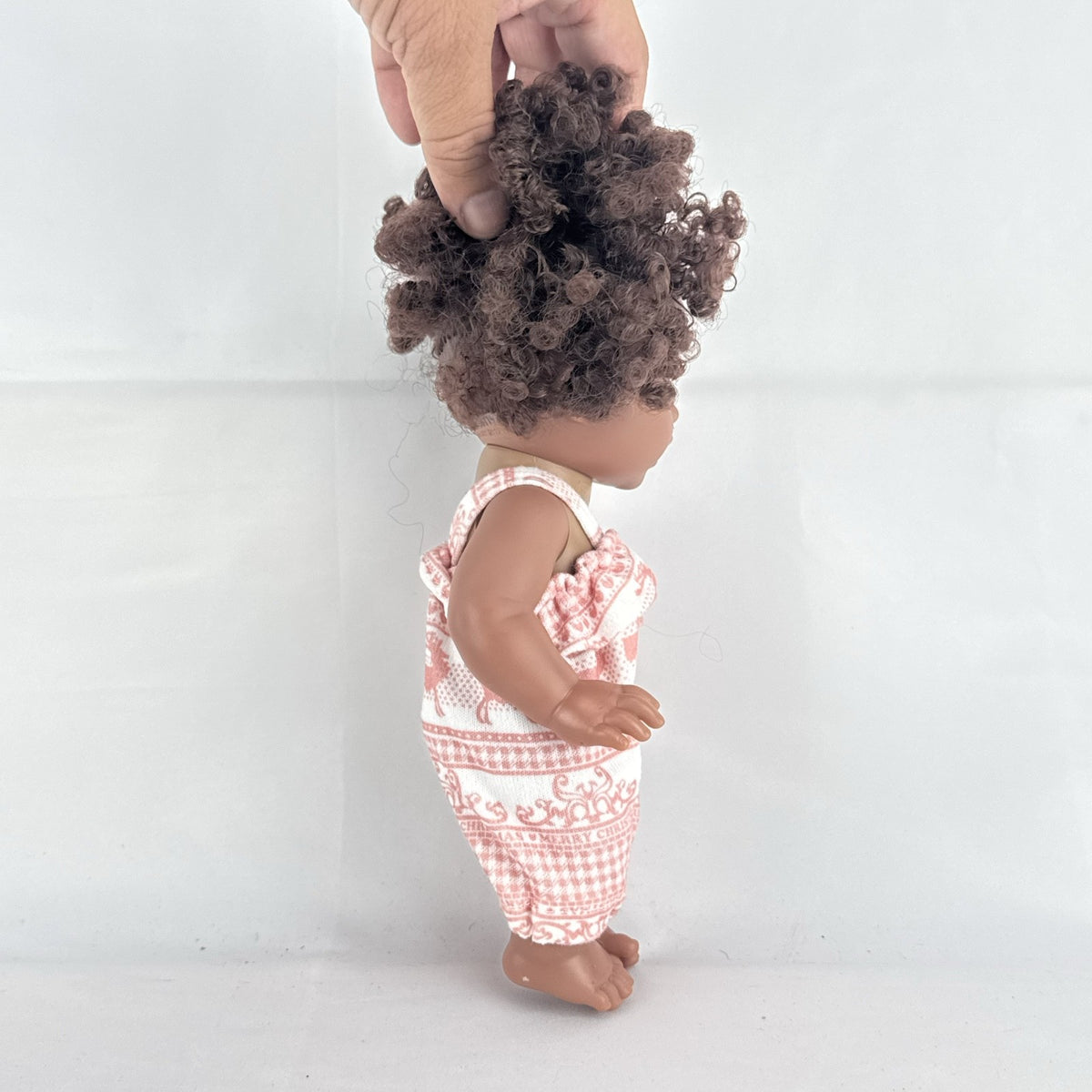 Smart Zone 10-inch African American vinyl baby doll with dark brown curly afro puff pigtails in a pink reindeer romper
