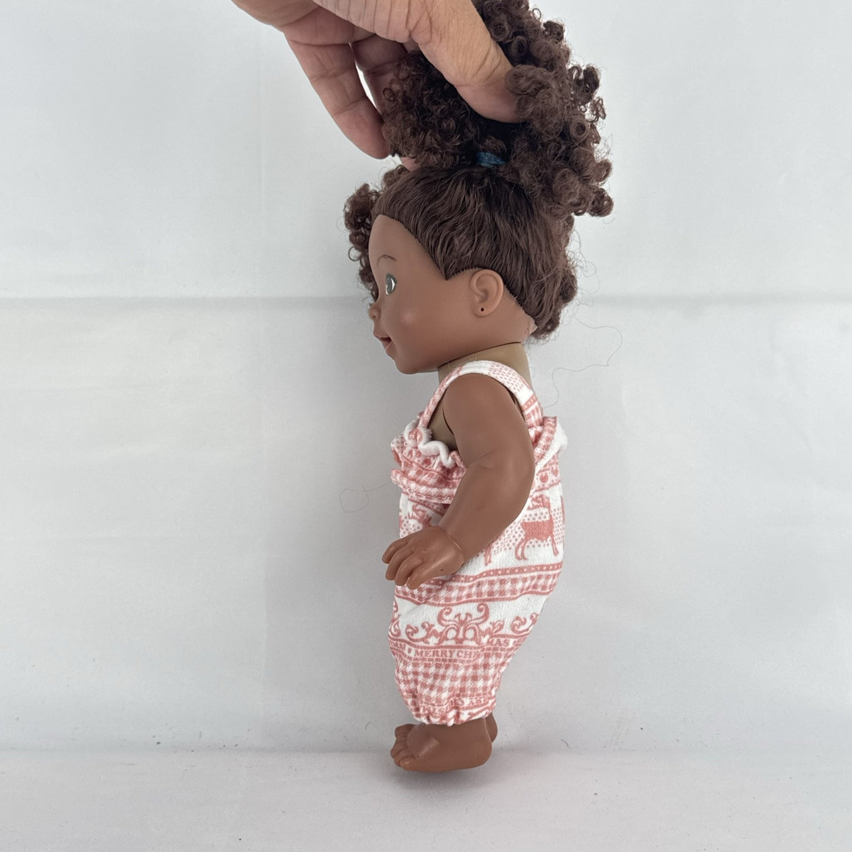 Smart Zone 10-inch African American vinyl baby doll with dark brown curly afro puff pigtails in a pink reindeer romper