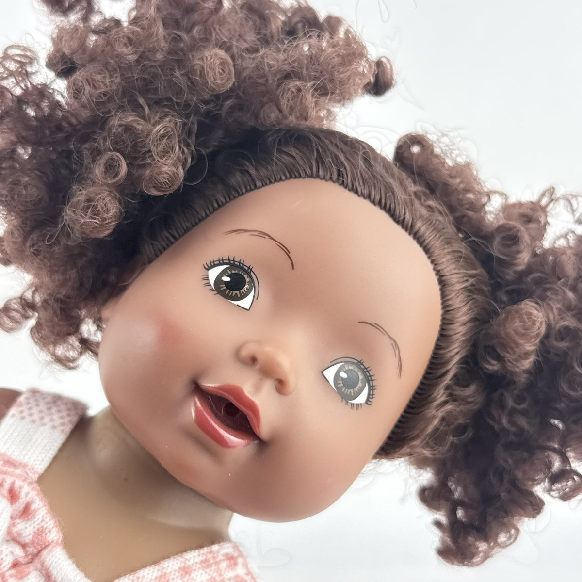 Smart Zone 10-inch African American vinyl baby doll with dark brown curly afro puff pigtails in a pink reindeer romper