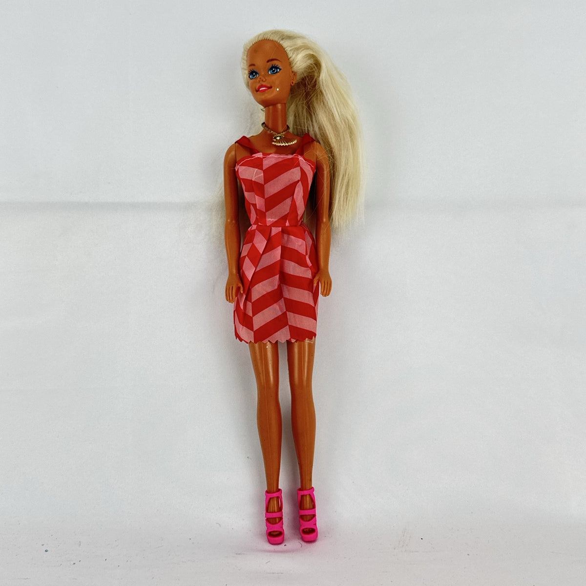 Vintage Mattel Barbie doll with blonde hair, Superstar face sculpt, chevron mini dress, and shell necklace
