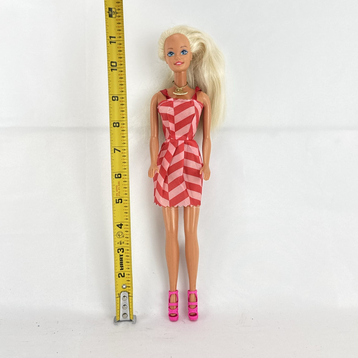 Vintage Mattel Barbie doll with blonde hair, Superstar face sculpt, chevron mini dress, and shell necklace