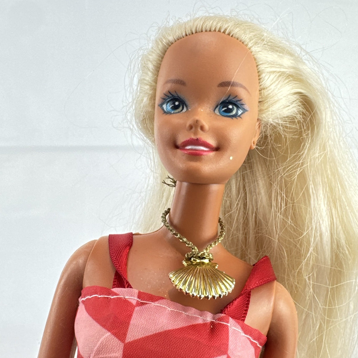 Vintage Mattel Barbie doll with blonde hair, Superstar face sculpt, chevron mini dress, and shell necklace