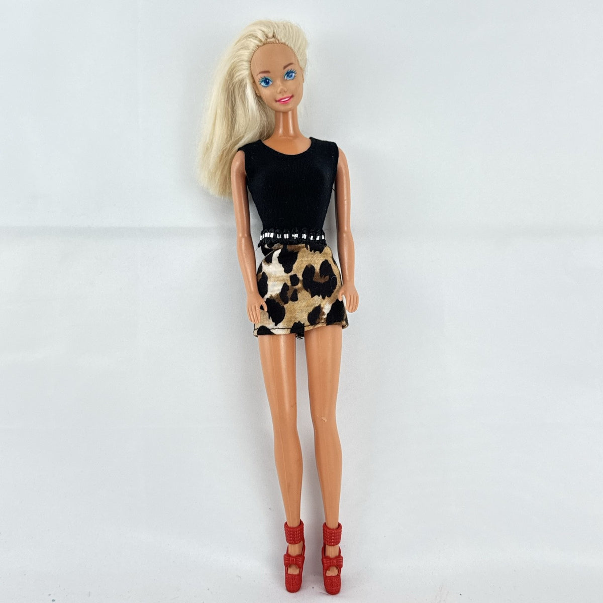 Vintage 1976 Mattel Superstar Barbie doll wearing a leopard print mini dress and red heels