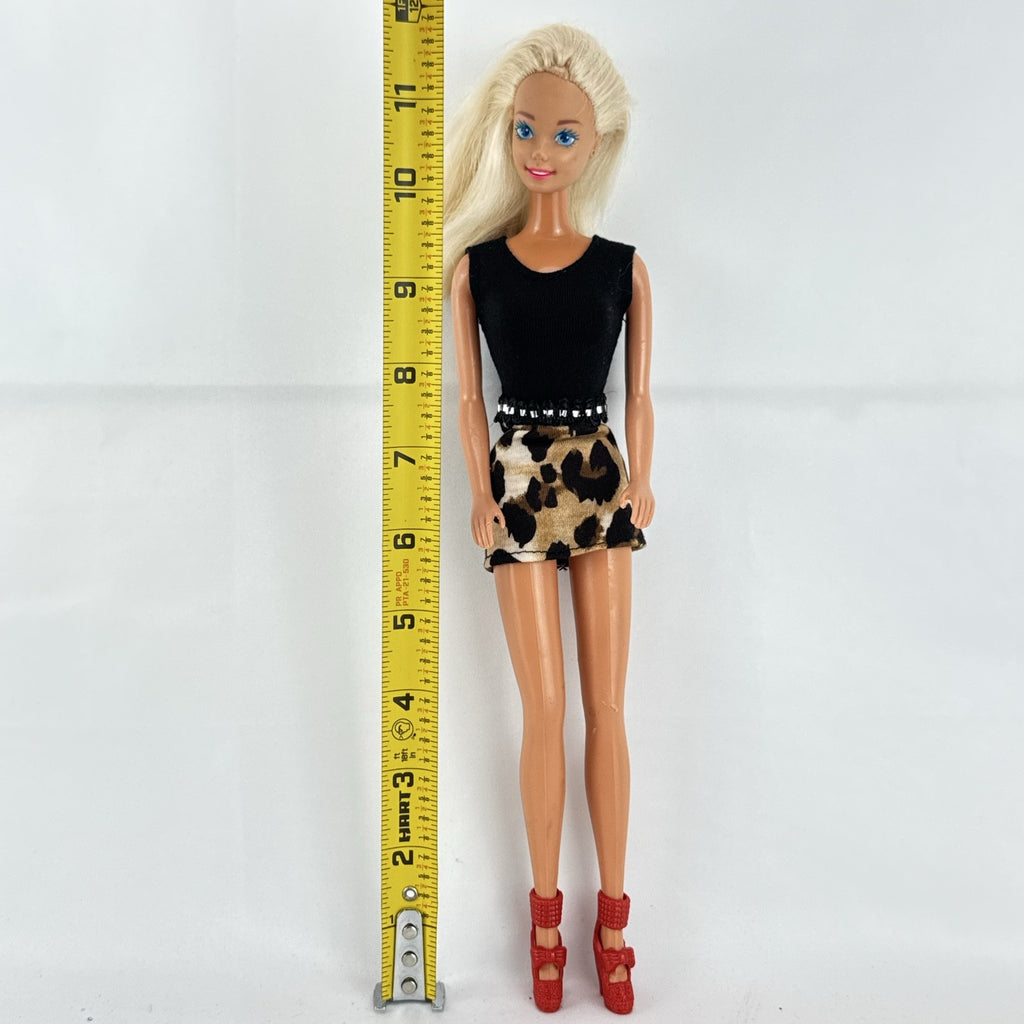 Vintage 1976 Mattel Superstar Barbie doll wearing a leopard print mini dress and red heels