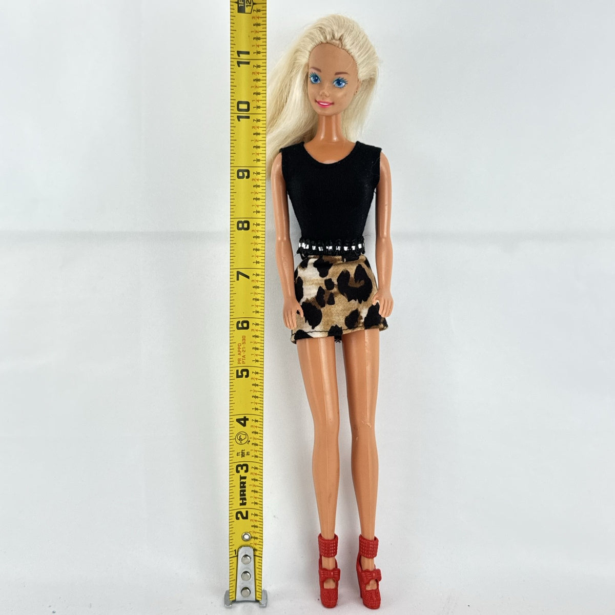 Vintage 1976 Mattel Superstar Barbie doll wearing a leopard print mini dress and red heels