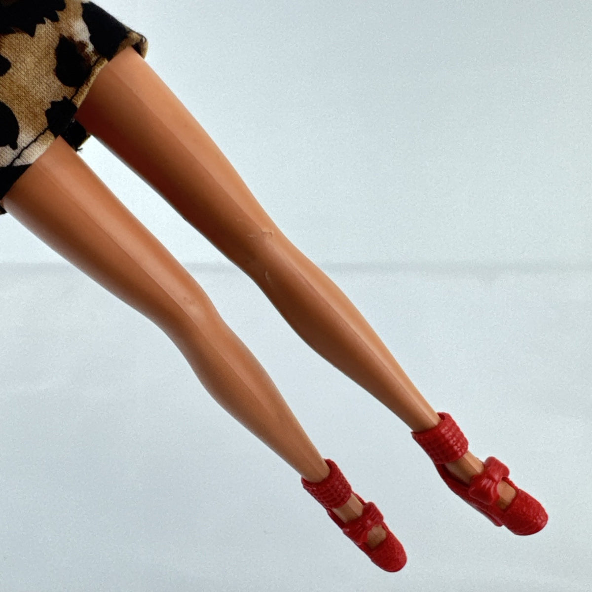 Vintage 1976 Mattel Superstar Barbie doll wearing a leopard print mini dress and red heels