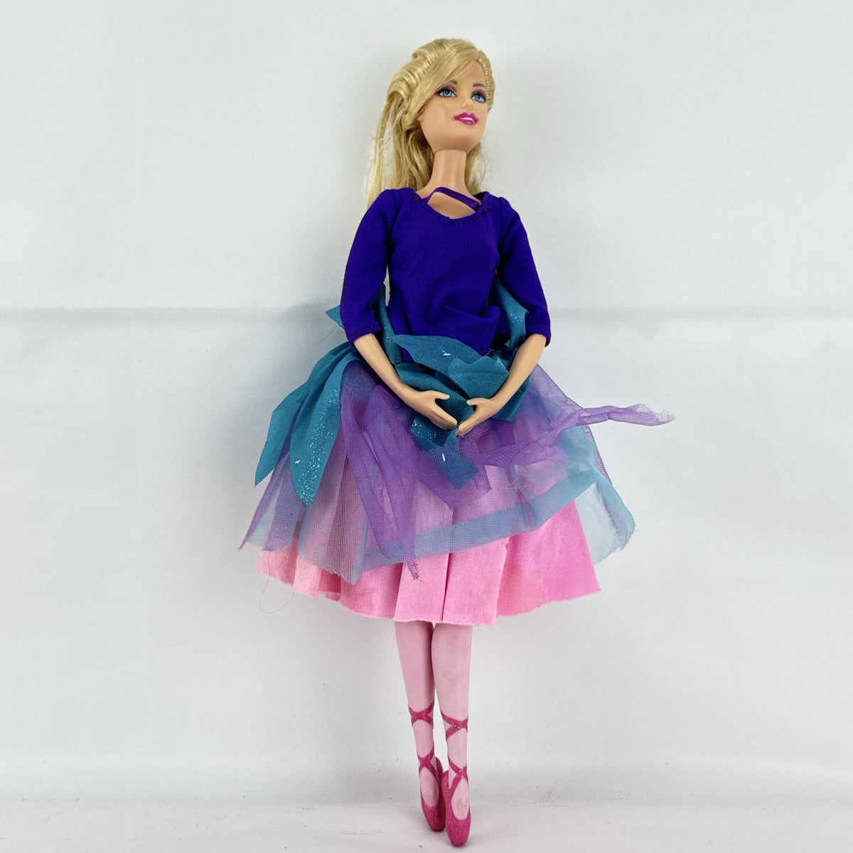 Mattel blonde Barbie ballerina doll in purple bodice and layered pink and teal tulle tutu