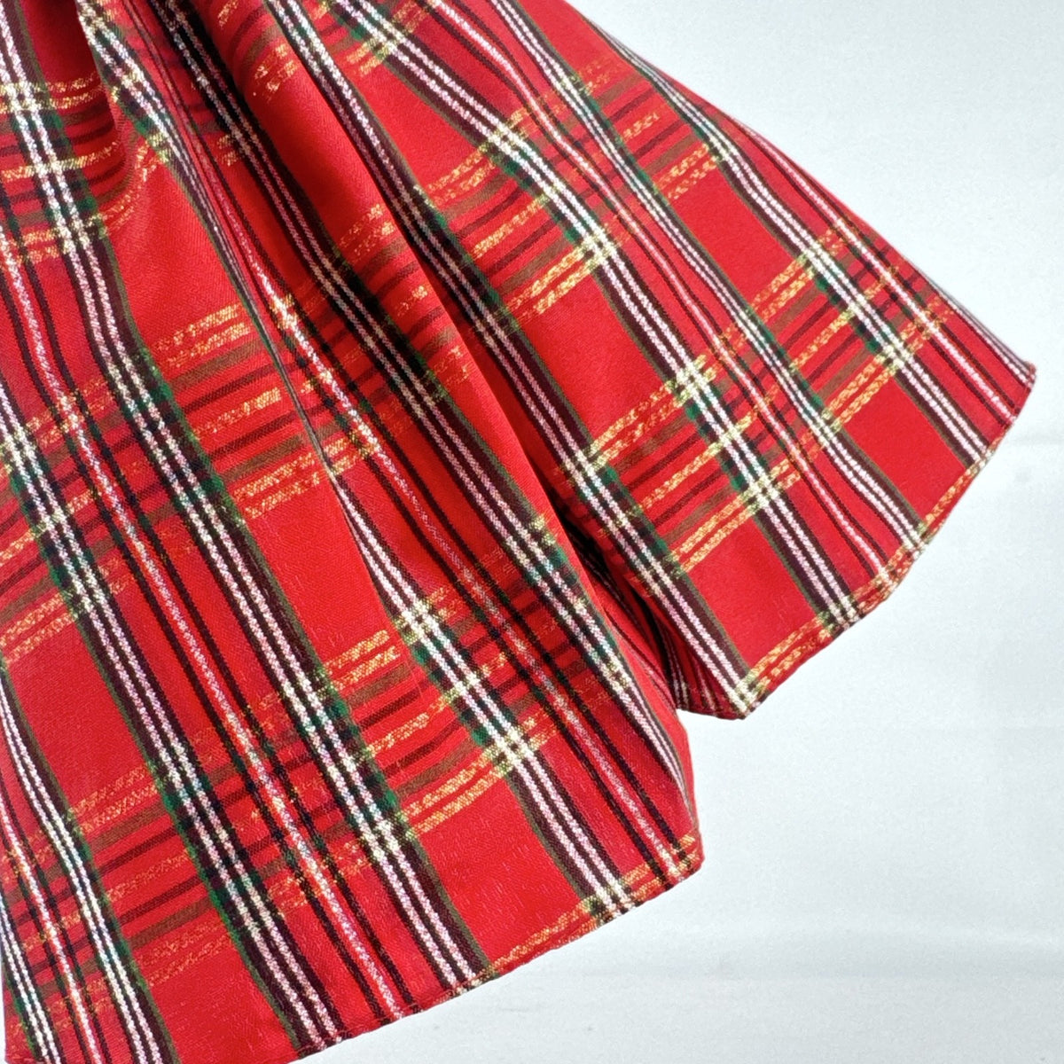 Mattel 2023 Holiday Barbie doll with blonde hair wearing a one-shoulder red plaid and tulle ballgown