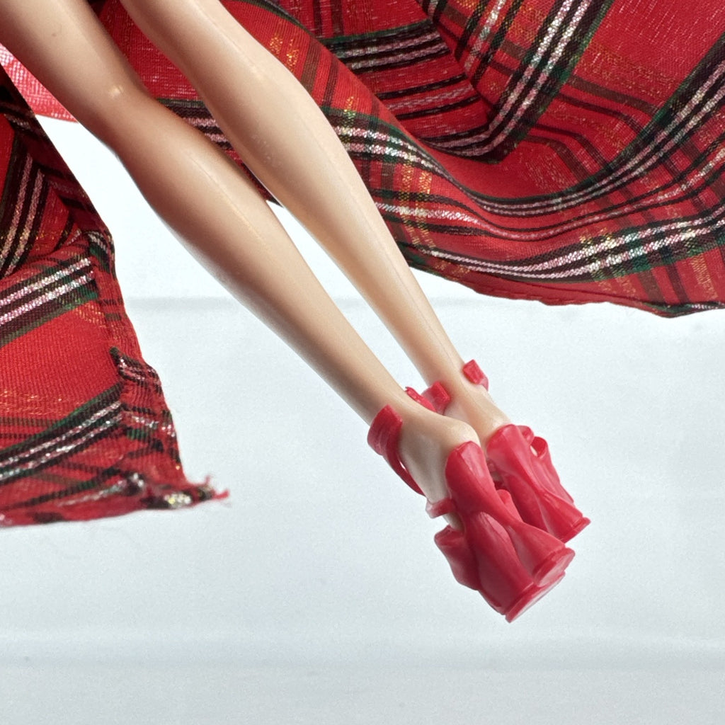 Mattel 2023 Holiday Barbie doll with blonde hair wearing a one-shoulder red plaid and tulle ballgown