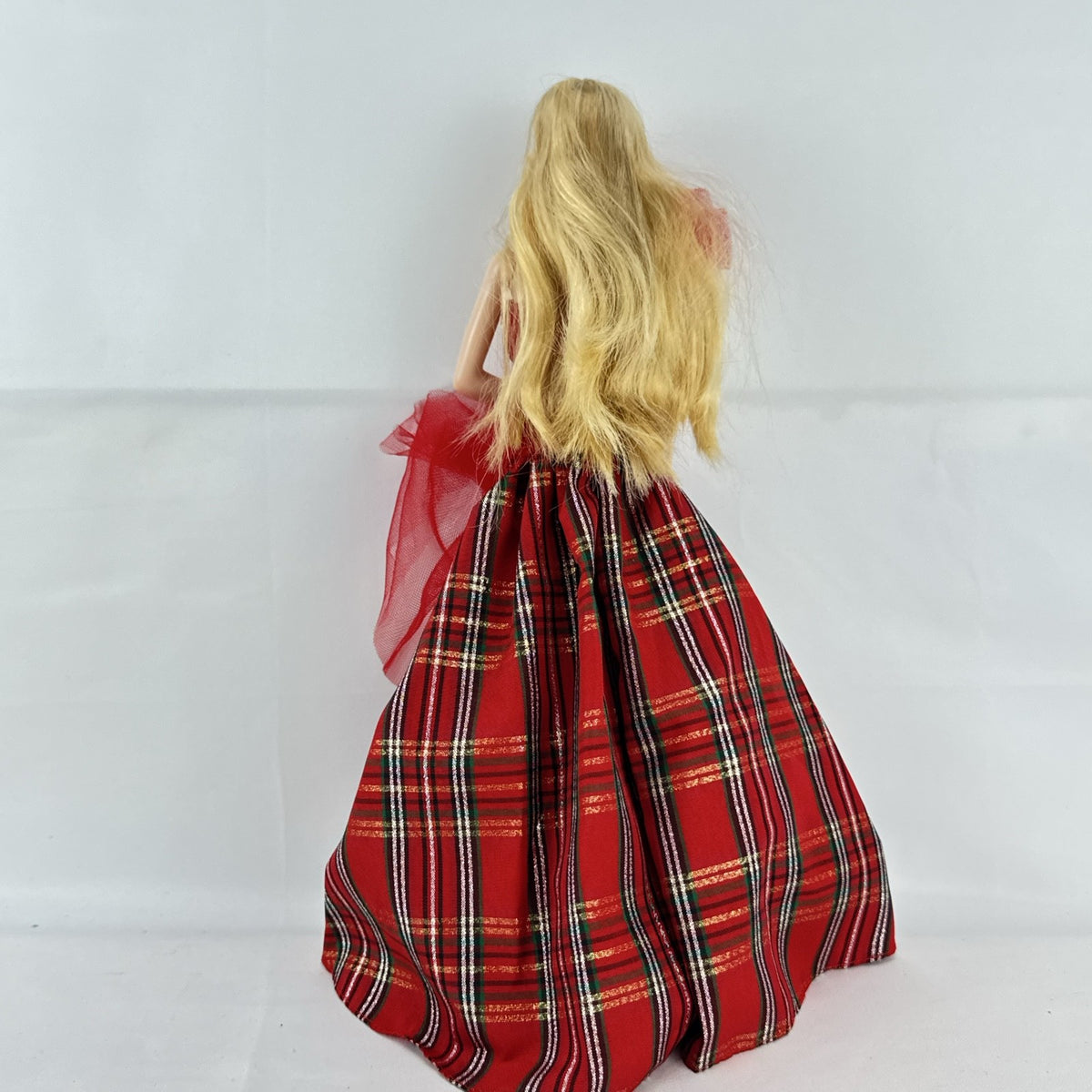 Mattel 2023 Holiday Barbie doll with blonde hair wearing a one-shoulder red plaid and tulle ballgown