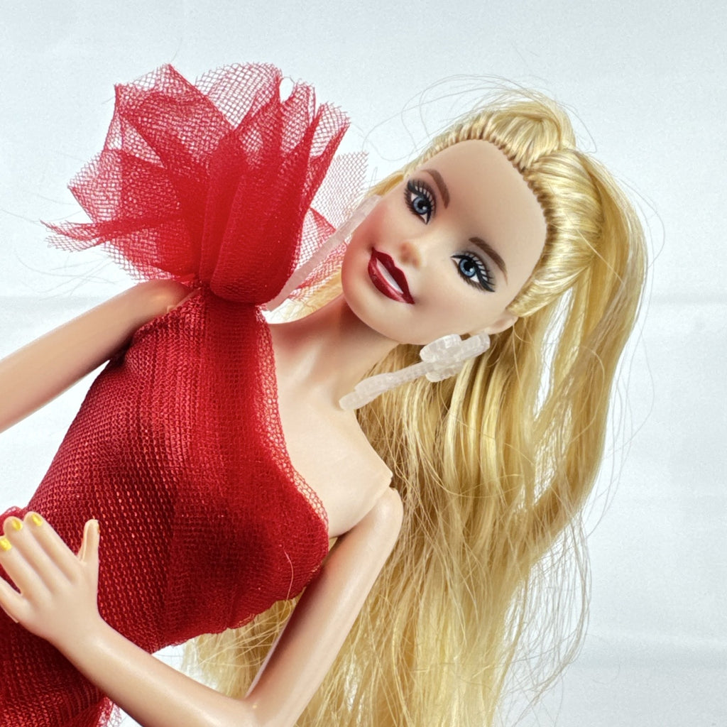 Mattel 2023 Holiday Barbie doll with blonde hair wearing a one-shoulder red plaid and tulle ballgown