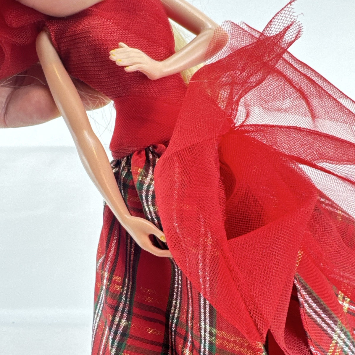 Mattel 2023 Holiday Barbie doll with blonde hair wearing a one-shoulder red plaid and tulle ballgown