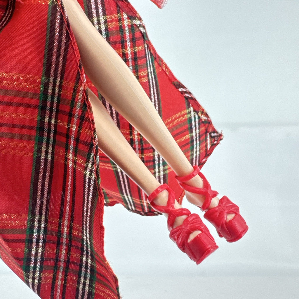 Mattel 2023 Holiday Barbie doll with blonde hair wearing a one-shoulder red plaid and tulle ballgown